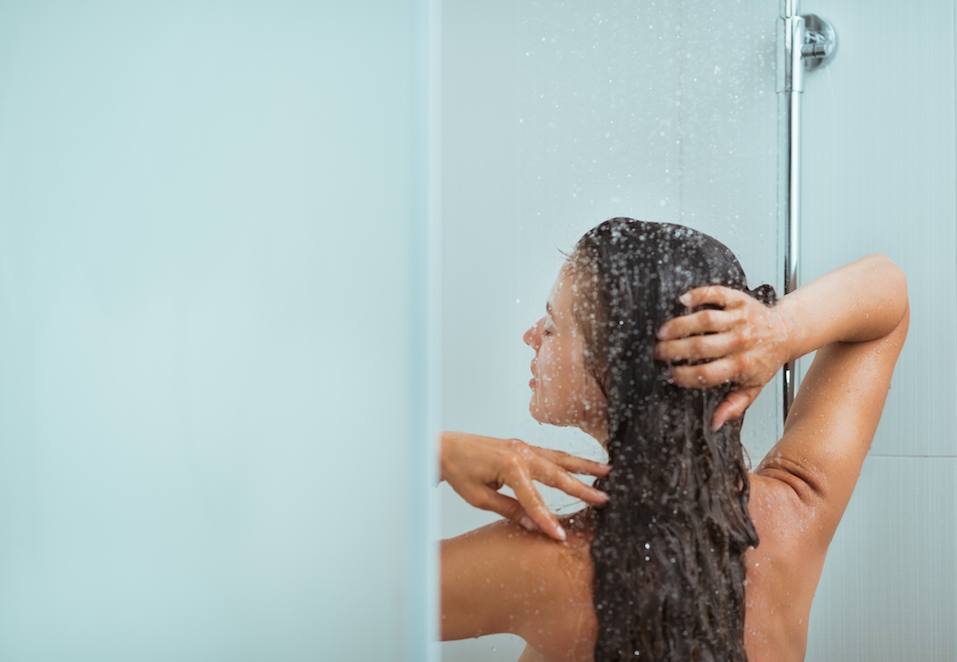 Woman with long hair taking shower