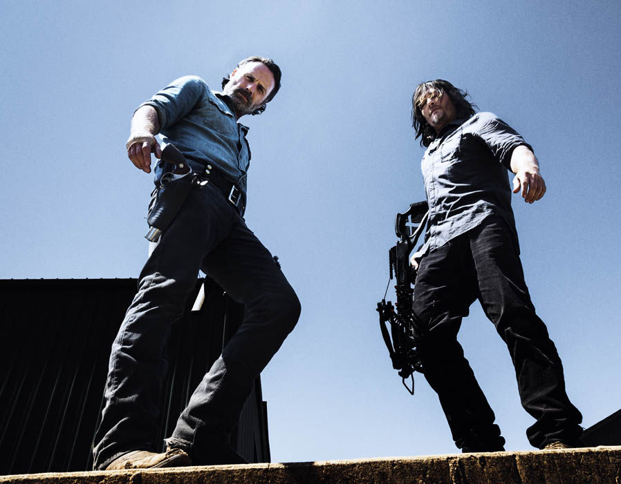 Daryl and Rick stand next to each other holding guns Daryl and Rick stand next to each other holding guns