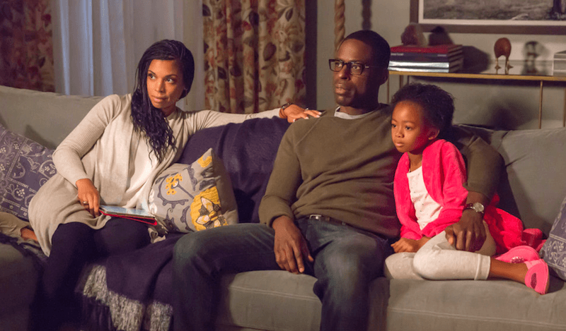 Beth, Randall, and their daughter sitting on a couch. Beth, Randall, and their daughter sitting on a couch.