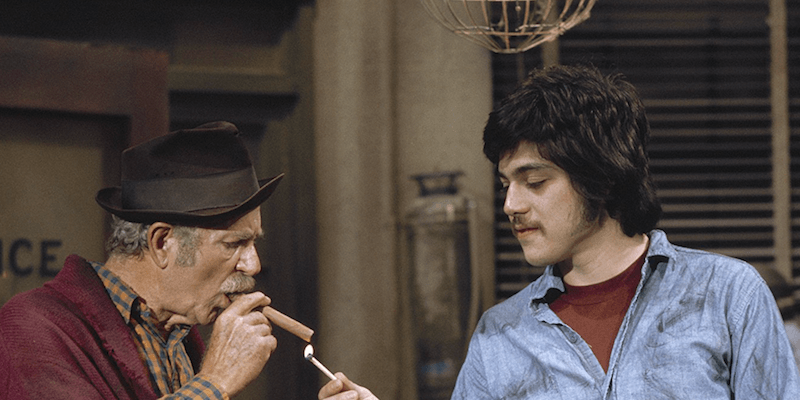 Chico lighting up a cigar with a match. Chico lighting up a cigar with a match.