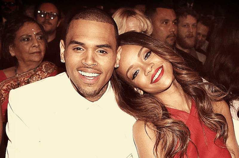 Chris Brown and Rihanna smiling together.