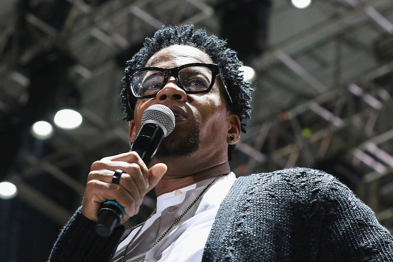 D.L. Hughley holds a microphone while speaking at a music event in Florida. D.L. Hughley holds a microphone while speaking at a music event in Florida.