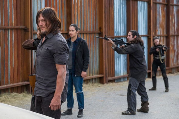 Daryl wants to battle the Saviors alone. | AMC Daryl stands in front of a group of people holding guns