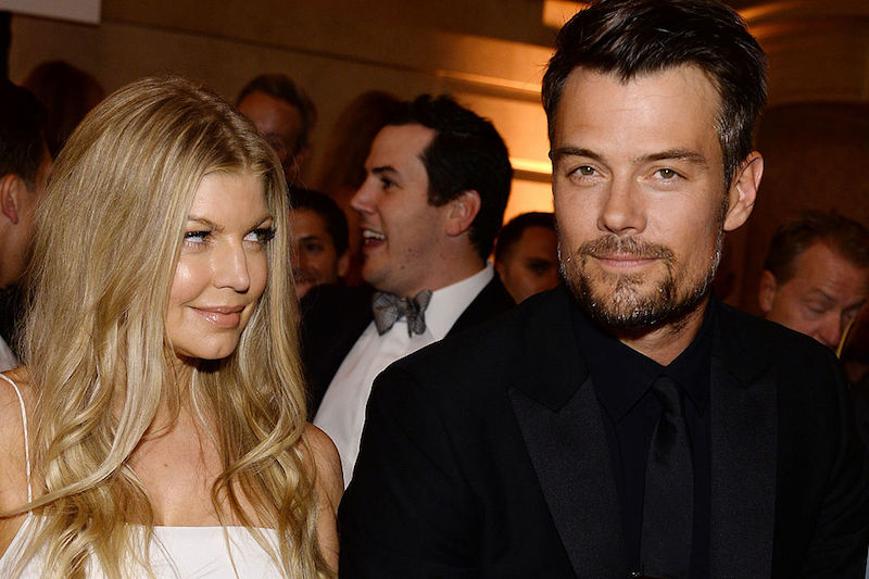 Fergie looks over at her ex-husband as they stand together at a formal event.