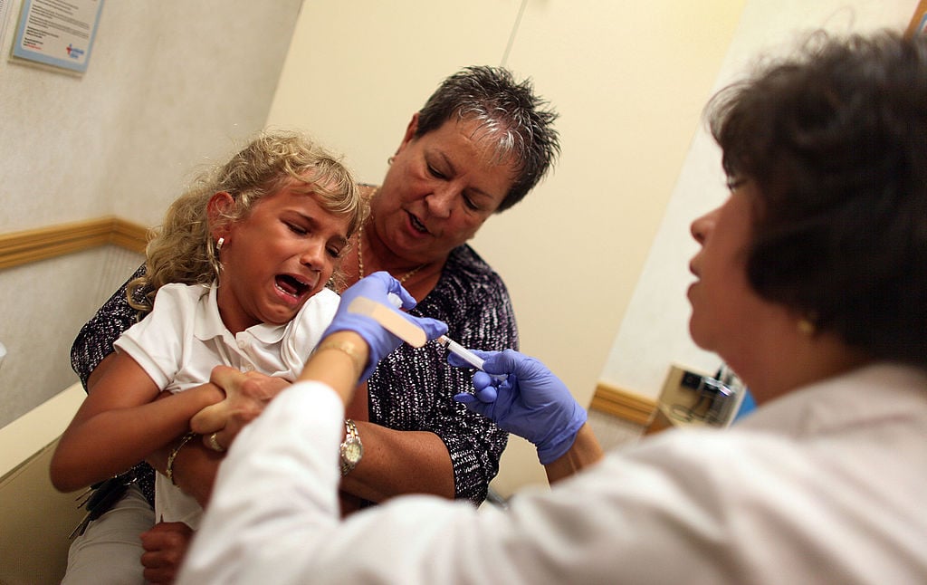 A girl gets a flu shot at CVS