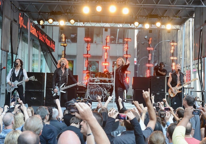 Def Leppard performs on stage at an outdoor concert
