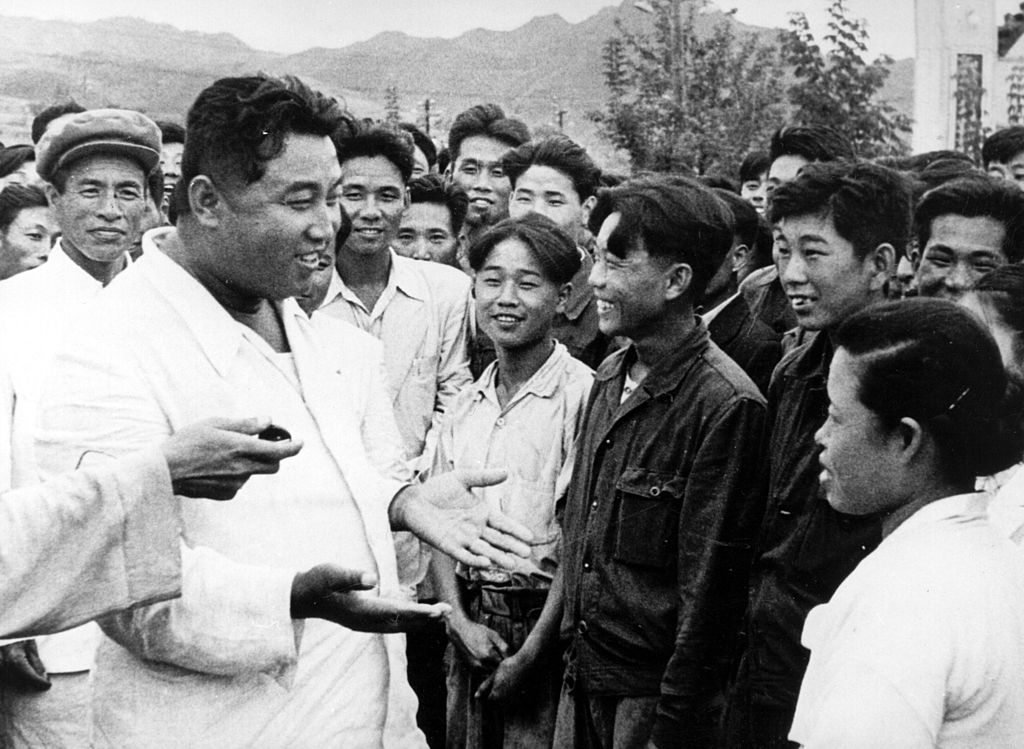 1967: North Korean dictator, Kim Il Sung, chats with workers on an unofficial visit to the Hichun Machine Plant.