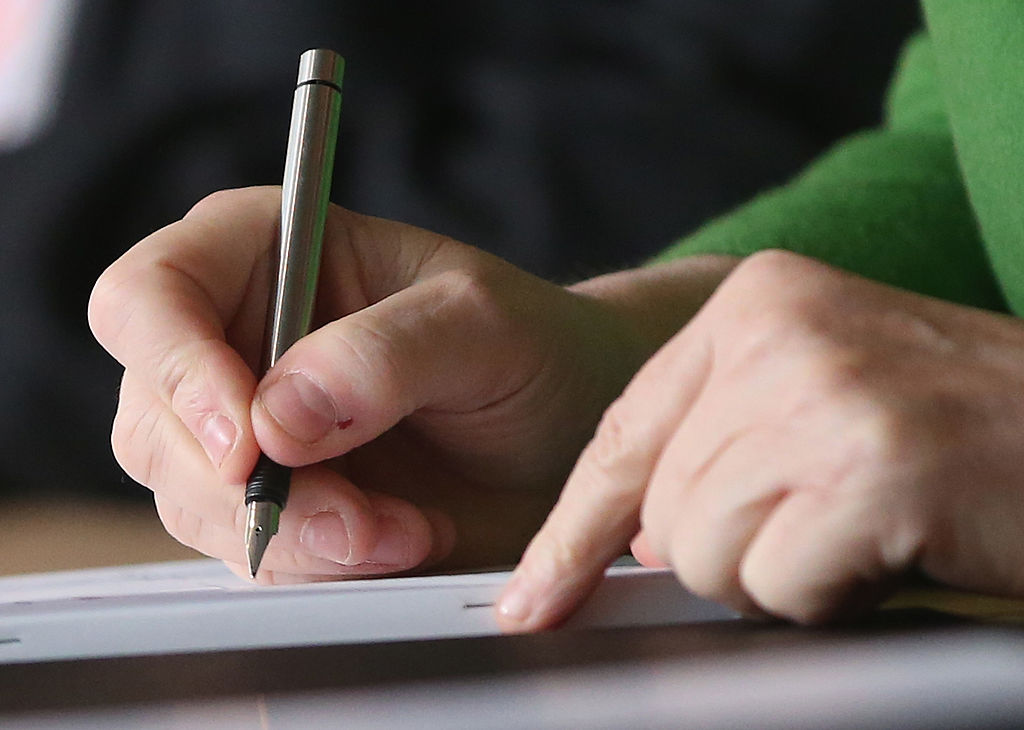 hand singing a paper
