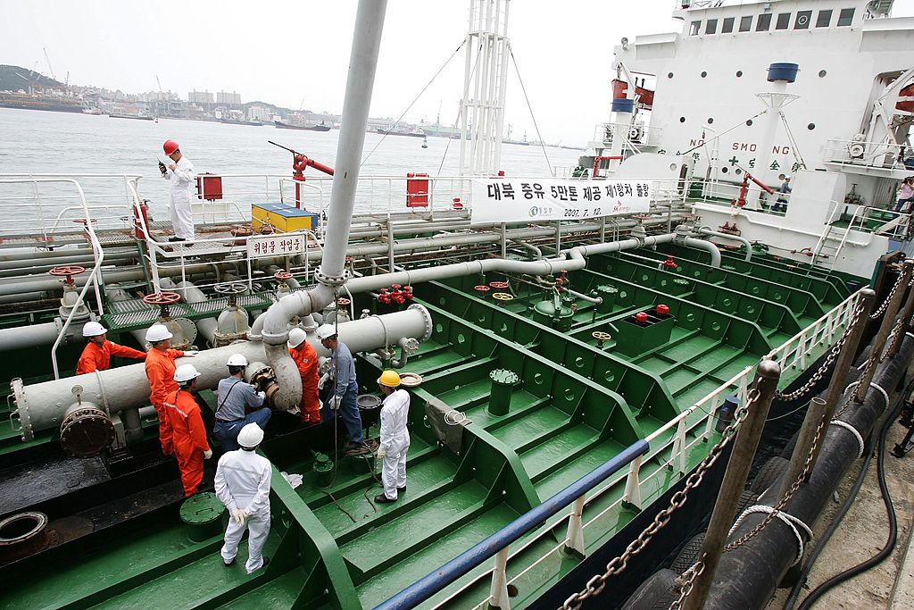 Korean workers fill an oil tanker