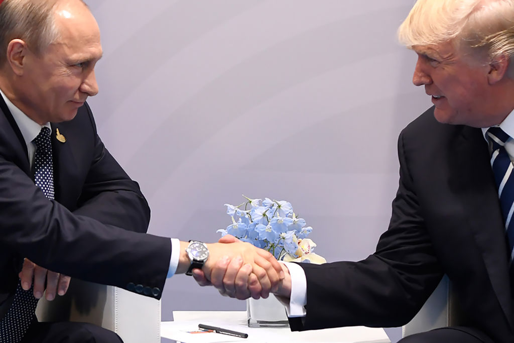 Trump shakes hands with Putin