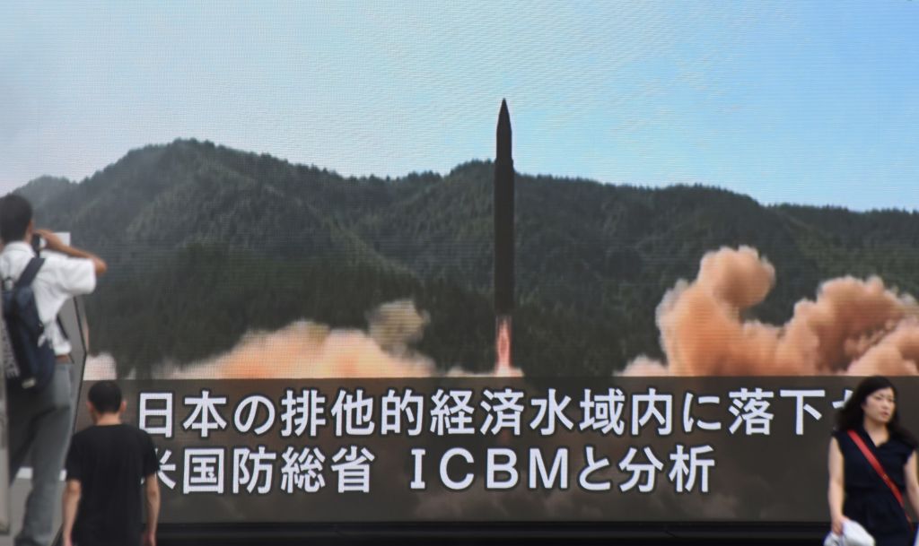 A screen broadcasts a missile test