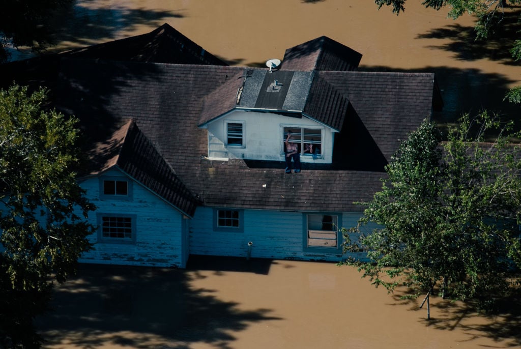This picture shows an aerial view of a home that has been flooded in Houston