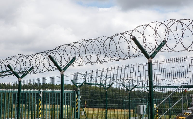 Security fence with barbed wire
