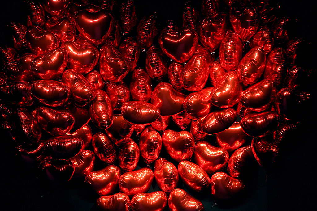 A bunch of red, heart-shaped balloons Bunch of heart-shaped balloons