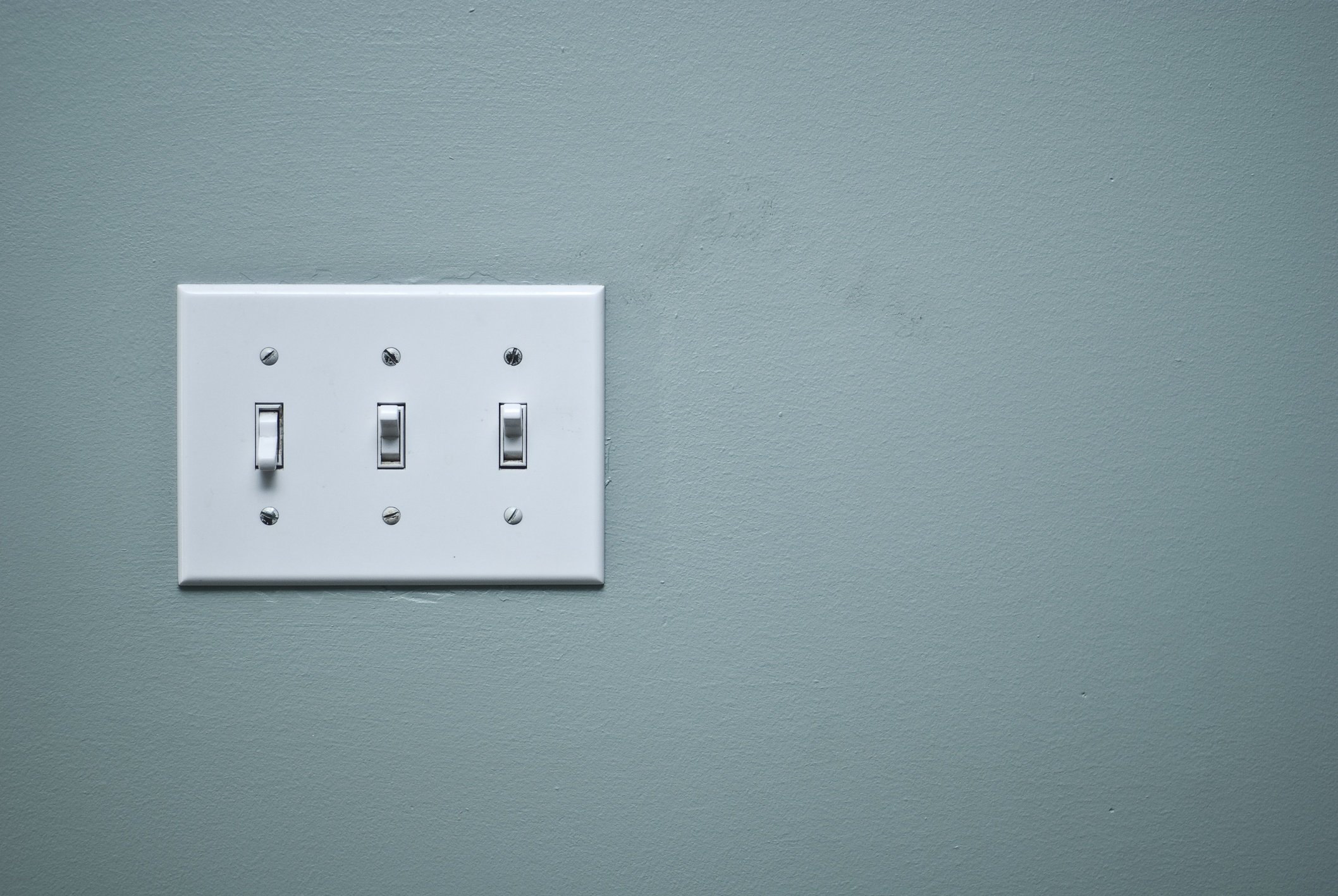 Light switch on a gray wall