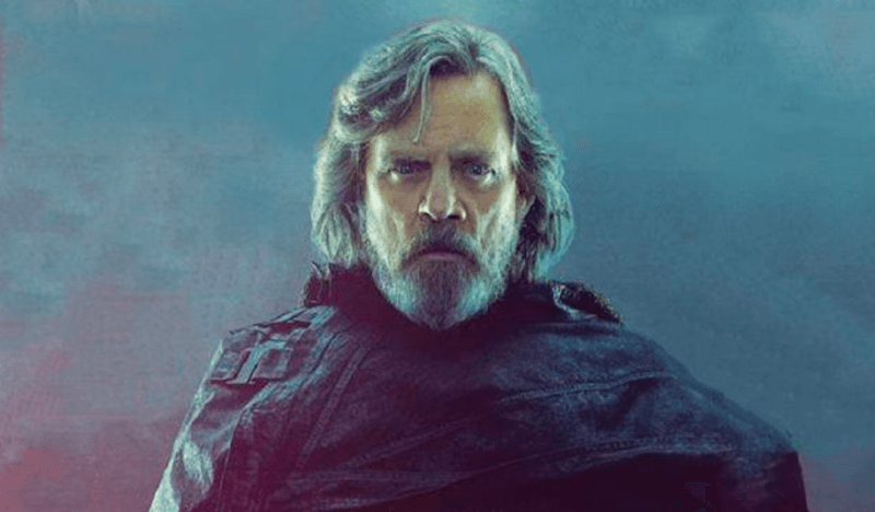 Luke Skywalker stands in a dark cape in front of a gray background. Luke Skywalker stands in a dark cape in front of a gray background.