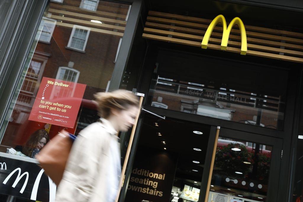 Woman walks past a McDonald’s