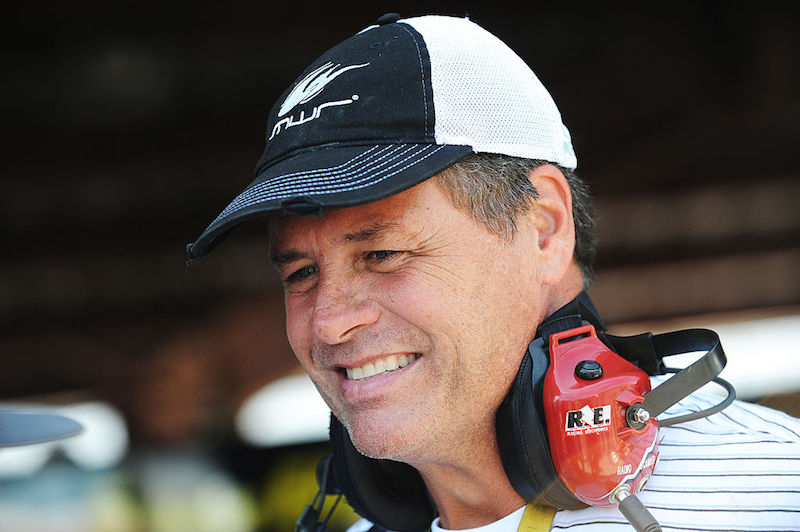 Michael Waltrip smiles while wearing a baseball cap. Michael Waltrip smiles while wearing a baseball cap.