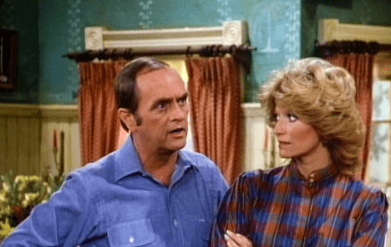 Bob and Mary stand in the living room talking to each other. Bob and Mary stand in the living room talking to each other.