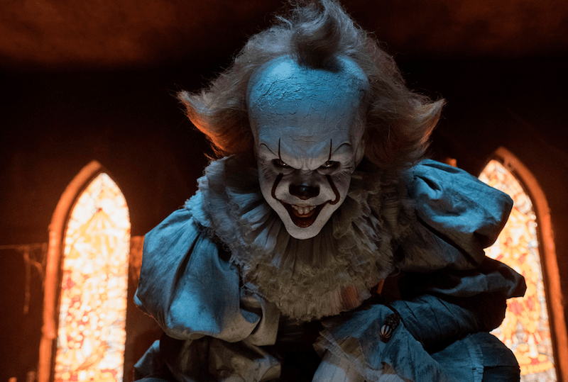 Pennywise kneeling in front of windows. Pennywise kneeling in front of windows.