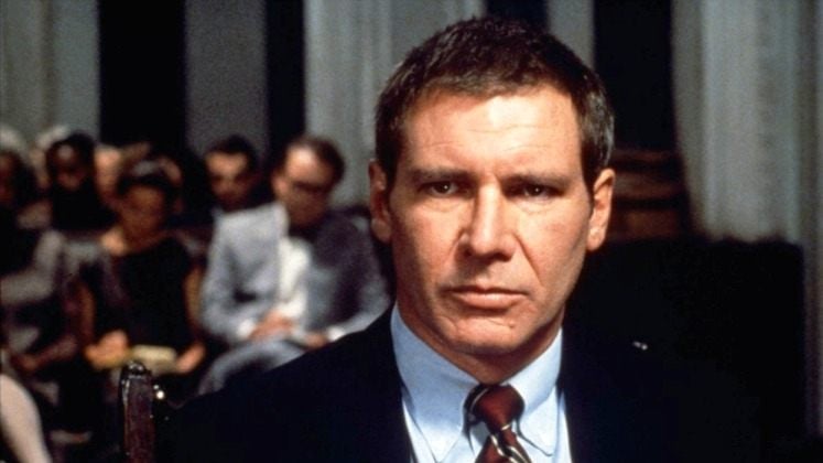 Harrison Ford wears a suit and looks ahead as Rusty Sabich in Presumed Innocent 