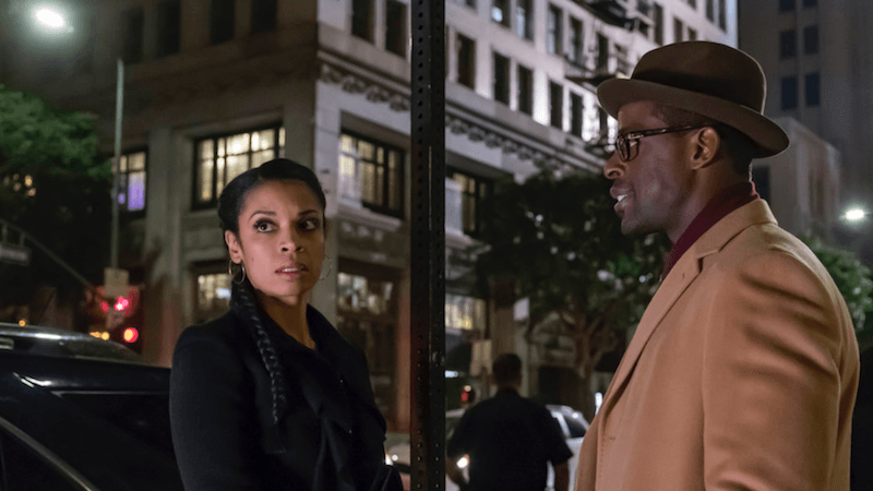 Beth stares angrily ahead while standing in front of Randall in a street. Beth stares angrily ahead while standing in front of Randall in a street.