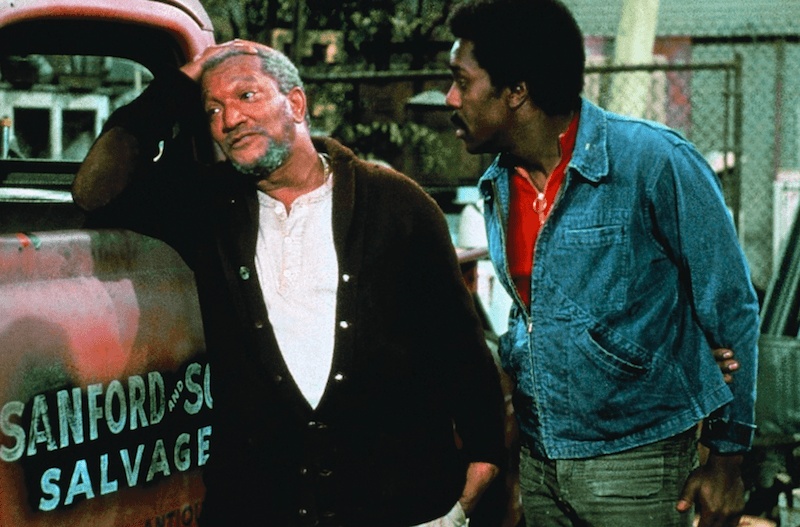 Two men speaking to each other in their yard. Two men speaking to each other in their yard.