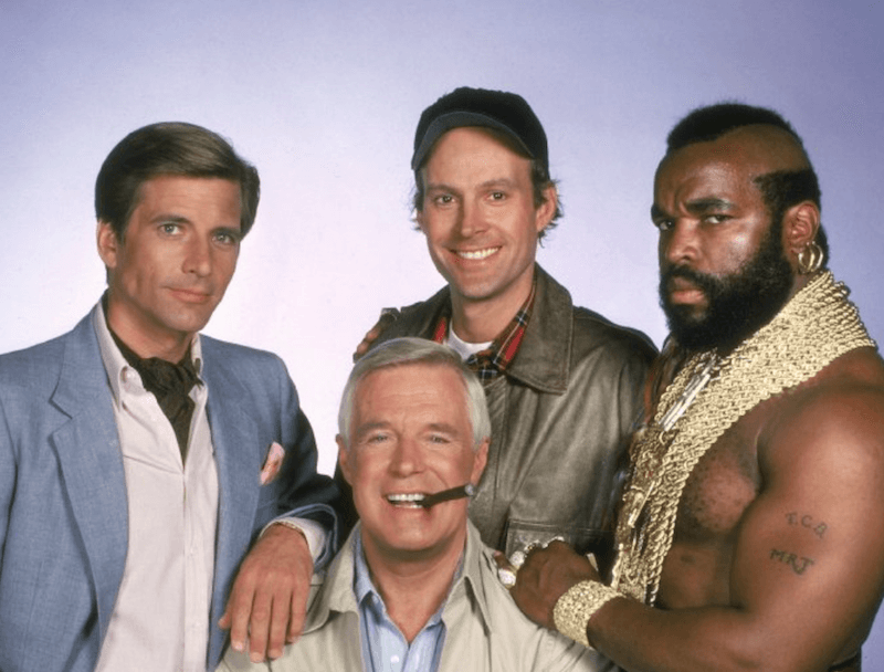 The A-Team characters smiling and posing together for group shot. The A-Team characters smiling and posing together for group shot.
