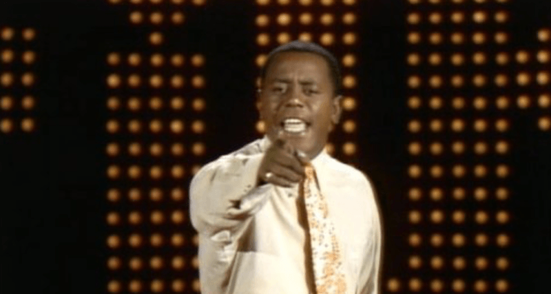 Flip points straight ahead while performing on stage. Flip points straight ahead while performing on stage.