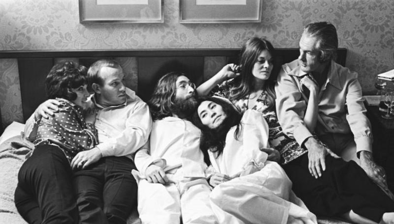  John Lennon, Timothy Leary, Yoko Ono, Tom Smothers, Rosemary Woodruff Leary lie down on a bed. 