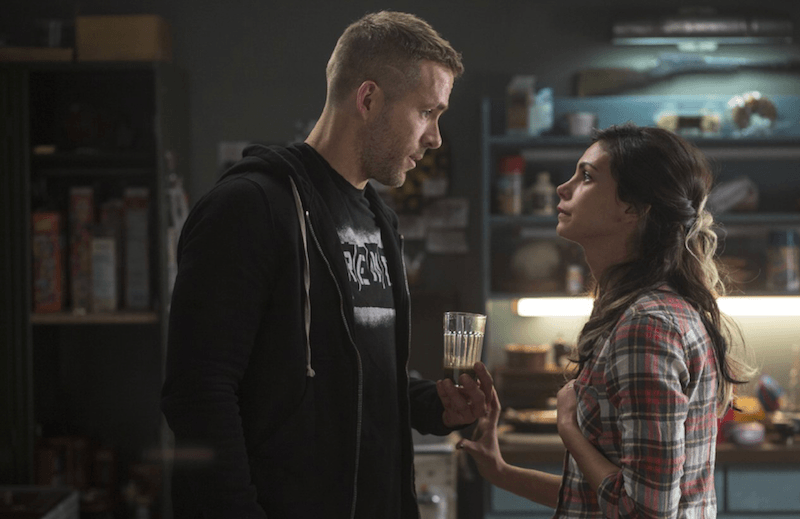 Wade and Vanessa in their kitchen holding a glass of juice.