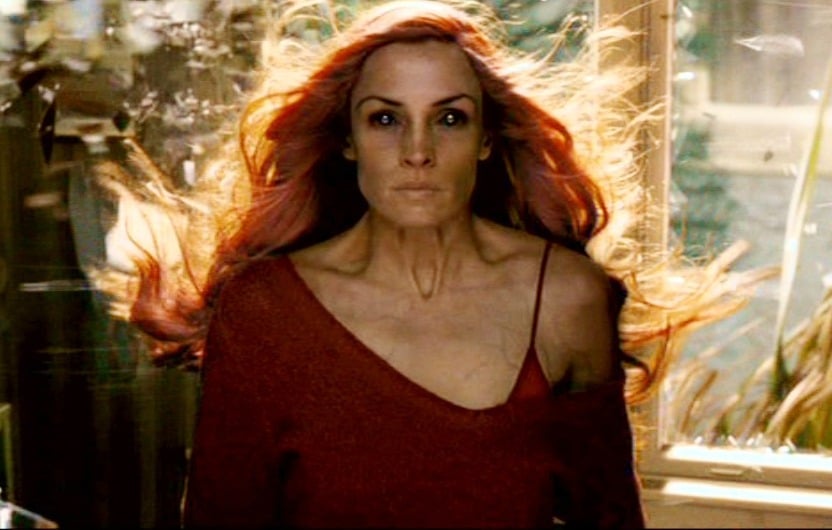 Jean Grey looks straight ahead while her red hair blows in the window Jean Grey looks straight ahead while her red hair blows in the window