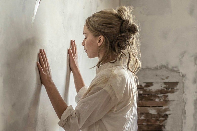 Jennifer Lawrence lays his hand against a wall in mother!