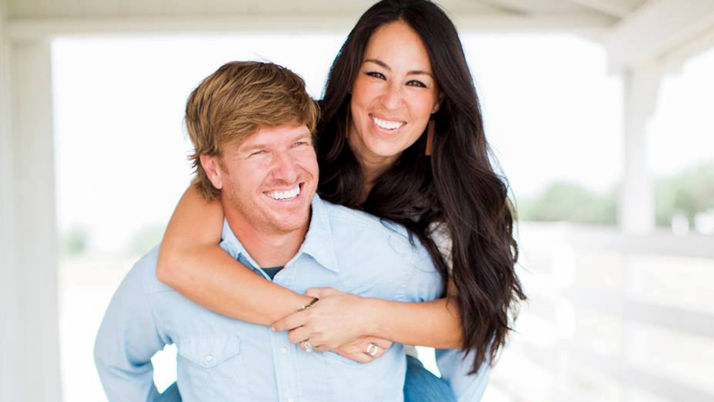 Chip and Joanna Gaines posing for photos and laughing. 