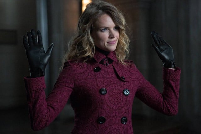 Barbara holds up her hands while wearing a Burgundy coat Barbara holds up her hands while wearing a Burgundy coat