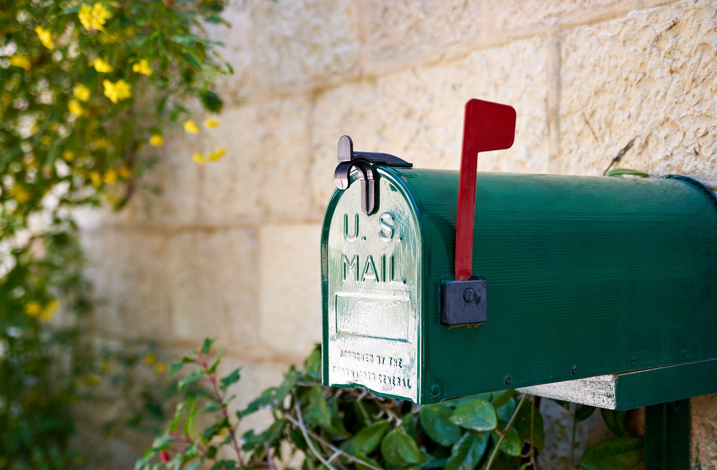 Green mailbox with red flag