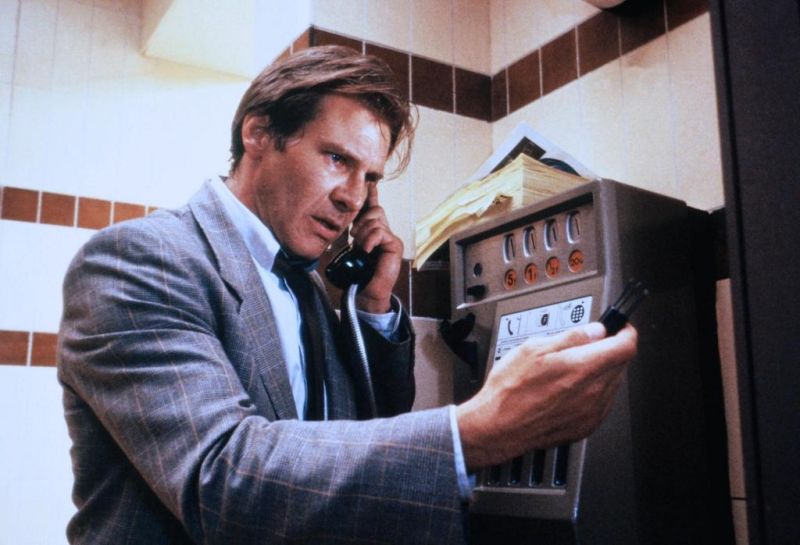 Harrison Ford holds a phone to his ear and looks at an item in his hand as Dr. Richard Walker in Frantic Harrison Ford holds a phone to his ear and looks at an item in his hand as Dr. Richard Walker in Frantic