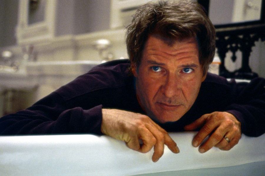Harrison Ford leans over the edge of a bath tub in Norman Spencer in What Lies Beneath