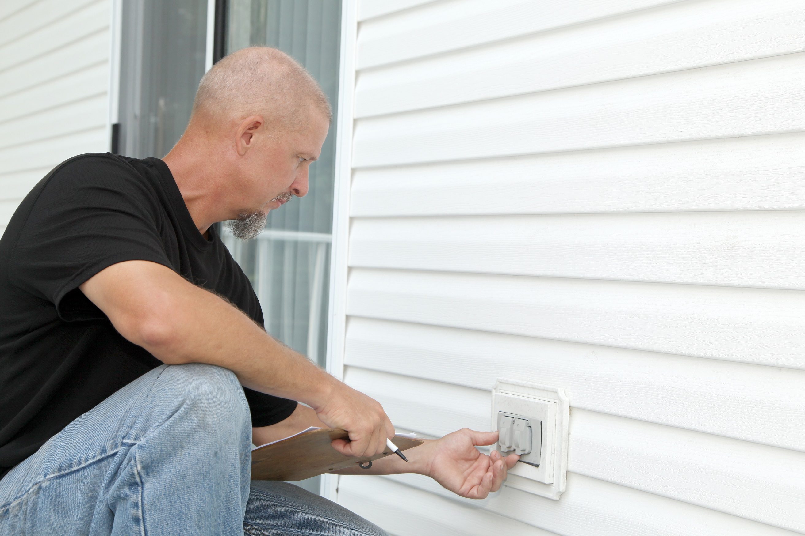 Contractor inspecting outlets