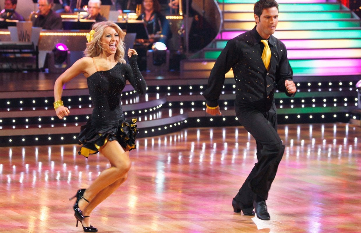 Julianne Hough and Chuck Wicks dance in black and yellow costumes