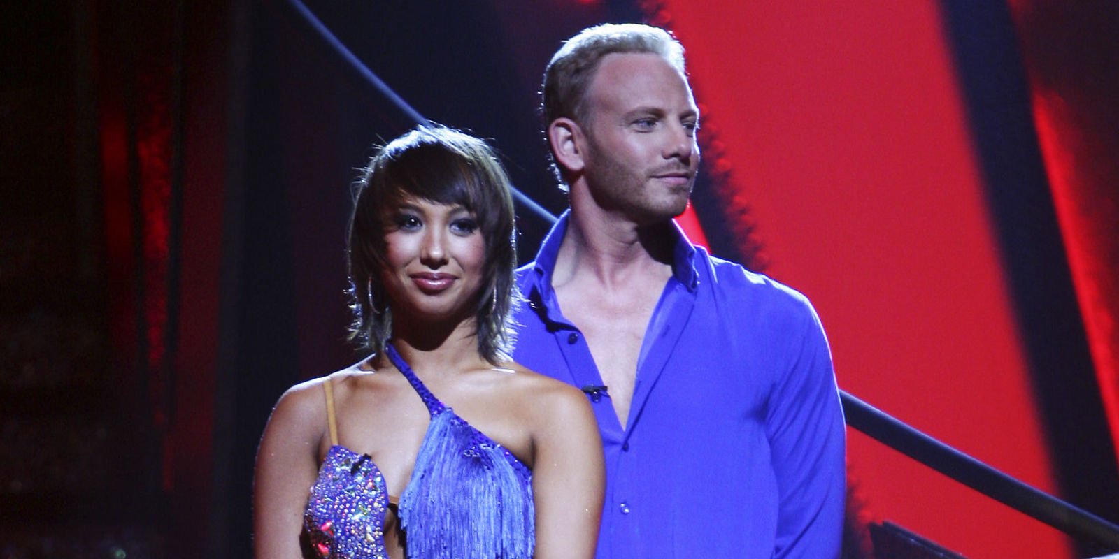 Cheryl Burke and Ian Ziering stand next to each other in colorful outfits on Dancing with the Stars