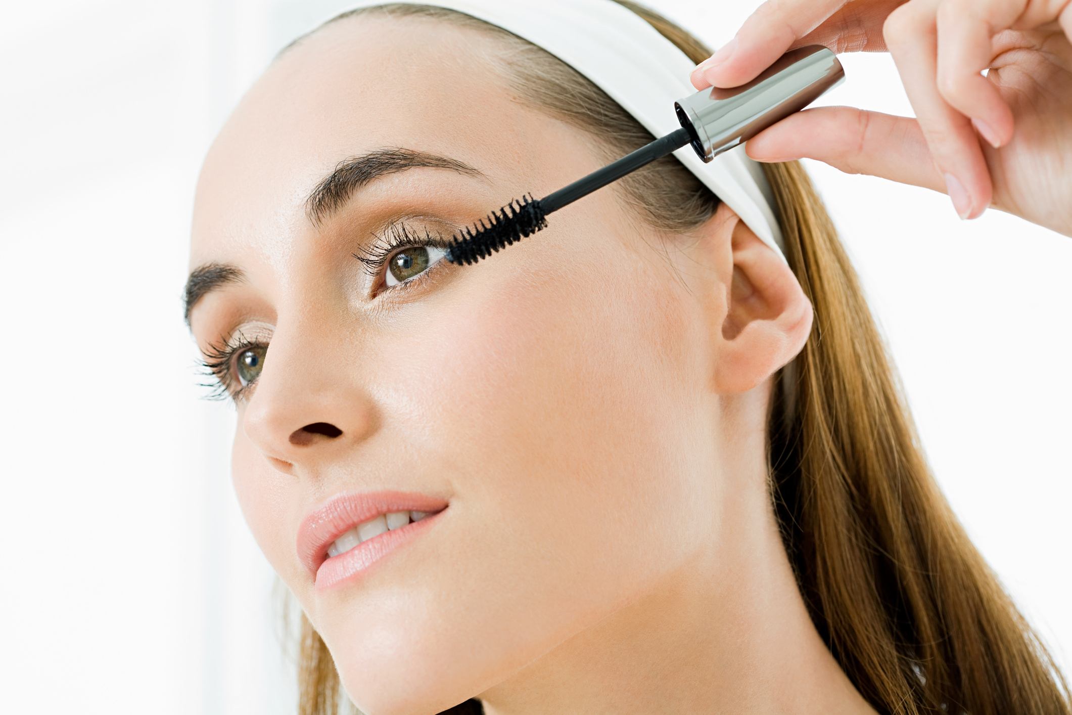 Young woman applying makeup Young woman applying makeup