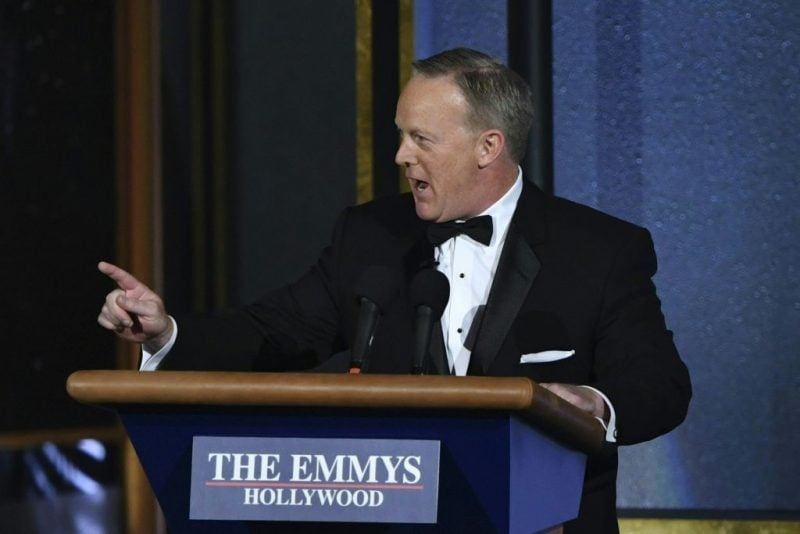 Sean Spicer stands behind a podium at the Emmys Sean Spicer stands behind a podium at the Emmys
