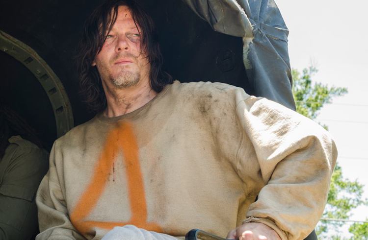 Daryl sits at the back of a truck wearing a garment with the number 4 on it Daryl sits at the back of a truck wearing a garment with the number 4 on it
