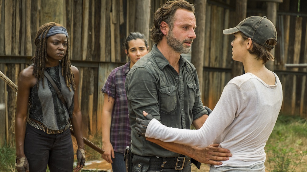 Rick faces Maggie and puts his hand on her waist