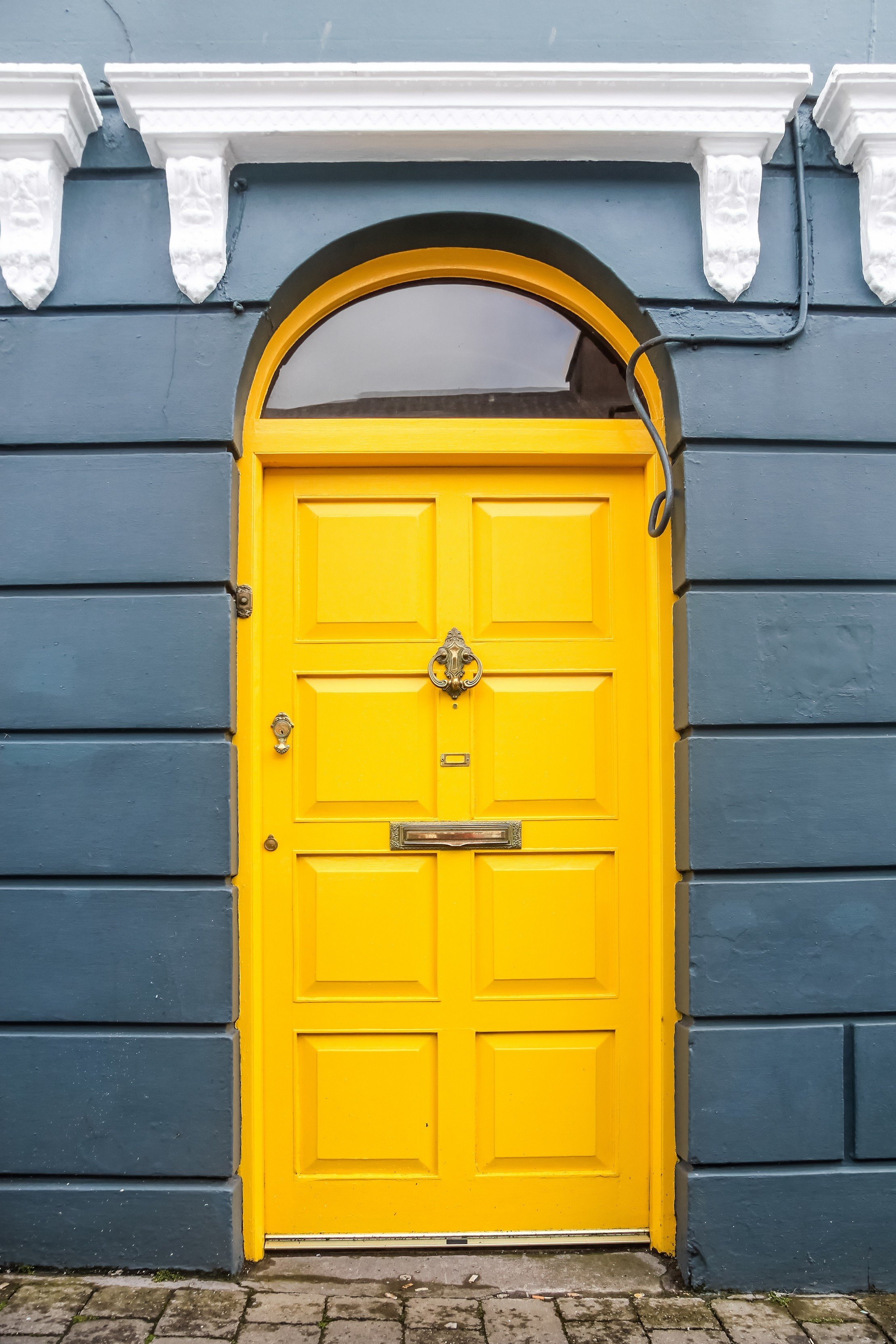 Yellow door on blue house in Ireland