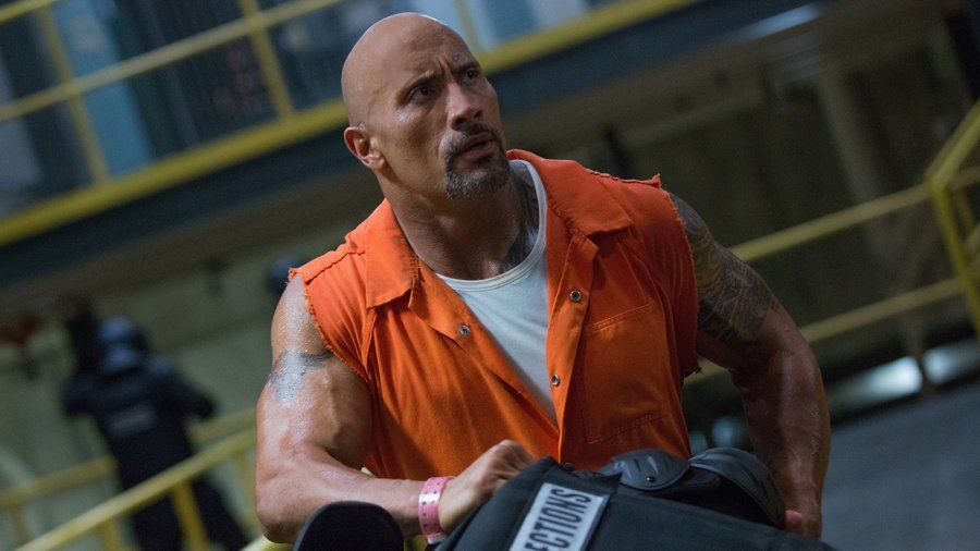 Dwayne "The Rock" Johnson wears an orange jumpsuit in The Fate of the Furious Dwayne "The Rock" Johnson wears an orange jumpsuit in The Fate of the Furious