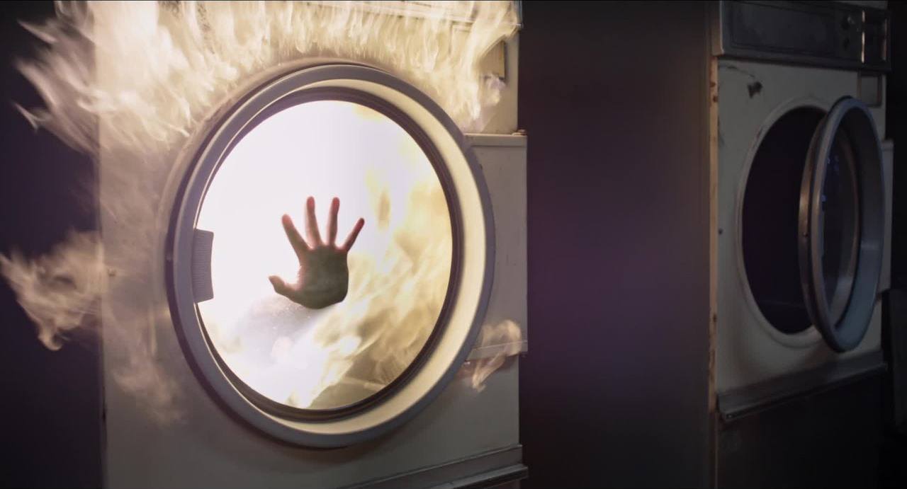 A hand is seen pressed up against a washing machine in the New Mutants trailer