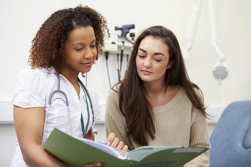 Nurse Showing Patient Test Results Nurse Showing Patient Test Results