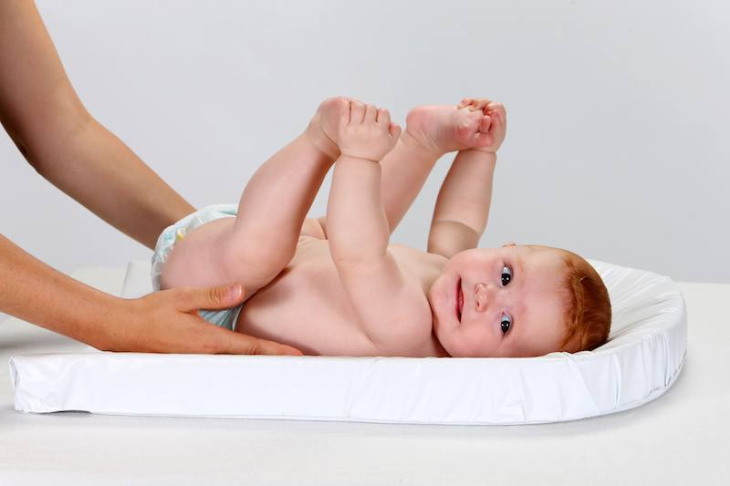 baby in a diaper holding its feet baby in a diaper holding its feet